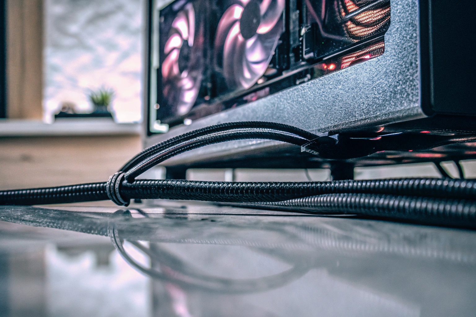 Ein Spieler, der intensiv auf einem leistungsstarken Setup spielt, mit Fokus auf der Grafikkarte und der Monitorverbindung. Spieler mit leistungsstarkem Gaming-Setup