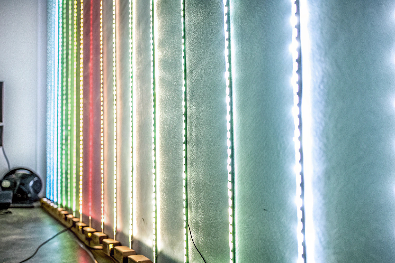 RGB-LED-Streifen, die an einer Wand angebracht sind und bunt leuchten RGB-LED-Streifen an der Wand